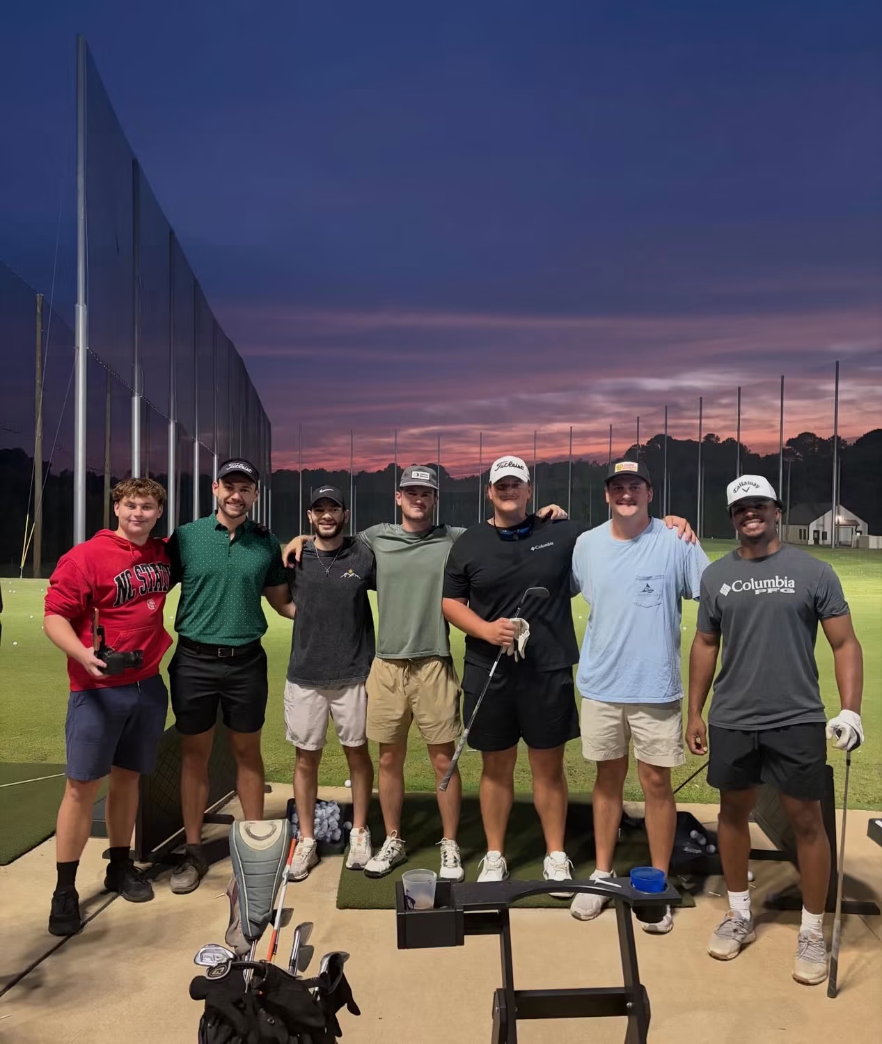 The crew at the TriGolf driving range at sunset